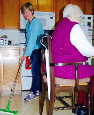 Homemaker cleaning the kitchen floor
